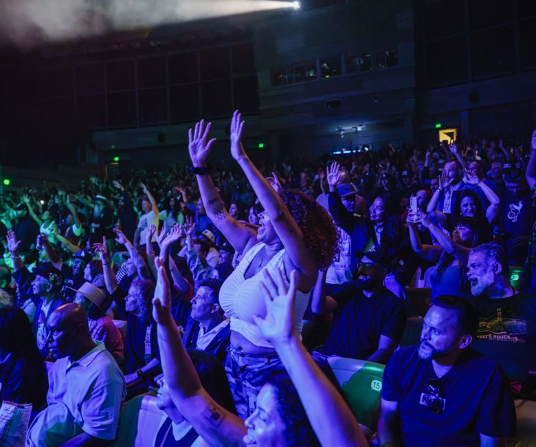 Fans at a theater raising their hands